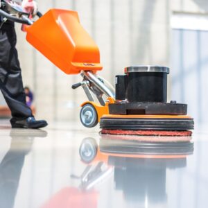 A man cleaning a freshly coated floor