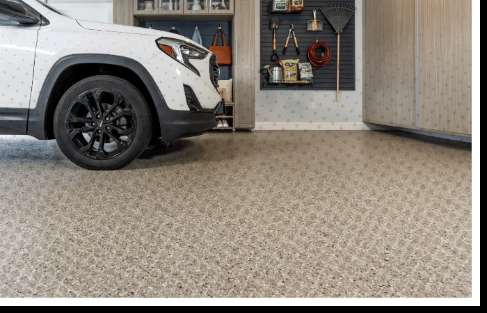 Durable beige flake Polyurea garage floor coating under car | Seamless residential garage flooring