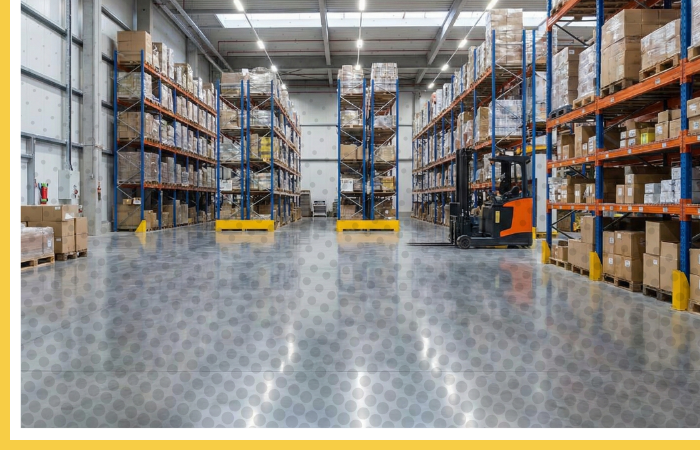 A large, clean commercial warehouse with a high-gloss polished concrete floor and tall storage racks.
