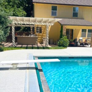 A slip-resistant decorative concrete coating on a modern luxury pool deck.